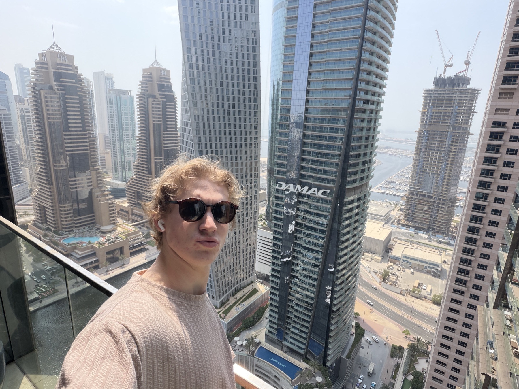 Tom on a balcony above Dubai Marina